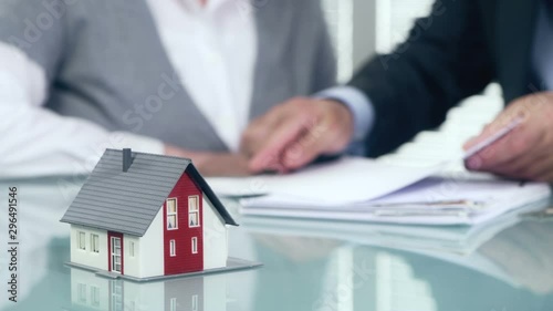 Estate agent shaking hands with customer after contract signature