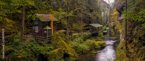 The Kamnitz Gorge - entrance (cabin, shed and boat) to the river port by the river flowing through rocky ravine in Bohemian Switzerland, Czech republic photo