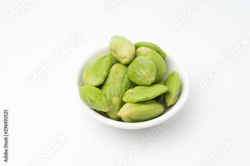 Raw Organic Orange Baby Carrots on black bowl, isolated white background