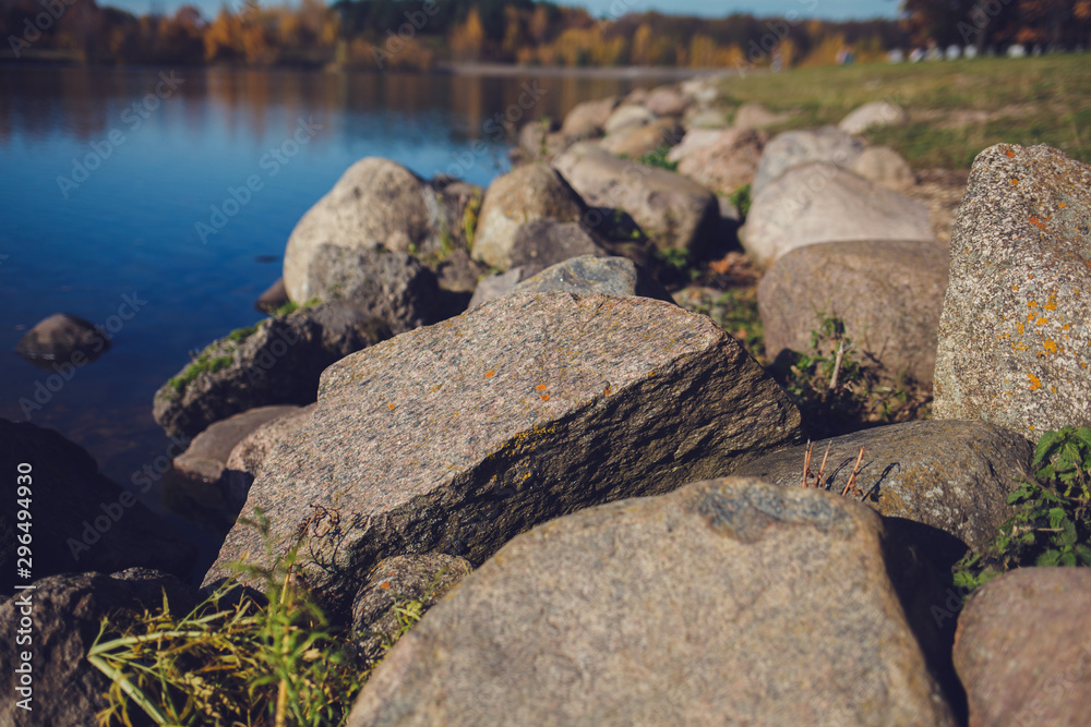 large stones on the background of the river in the autumn park large stones on the background of the river in the autumn park