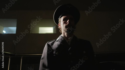 Military officer siting in a dark room