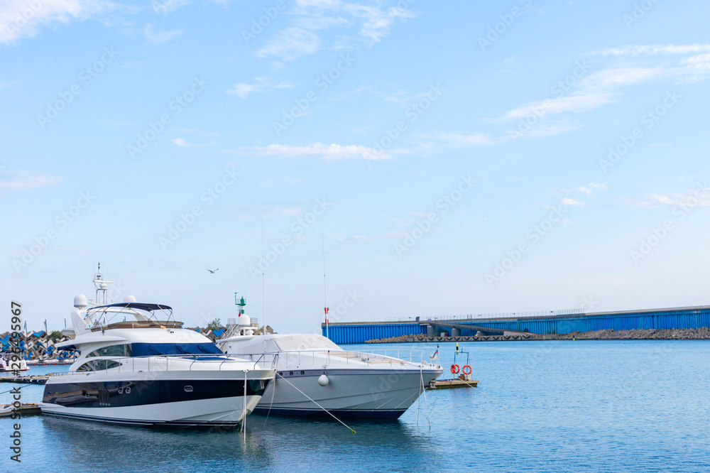 two luxury yachts parked at dock