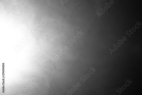 Smoke on a black background in the spotlight