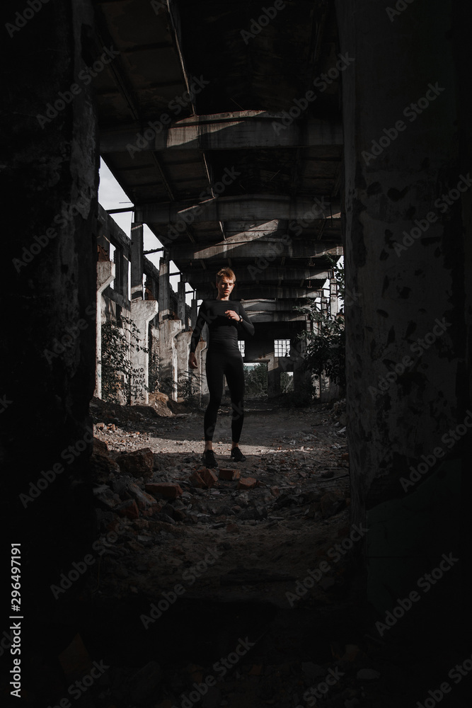 sports guy runner in an abandoned factory