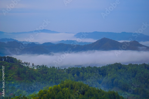 Beautiful landscape of green hills at sunrise. Buluh Payung Hill, Kebumen, Central Java, Indonesia