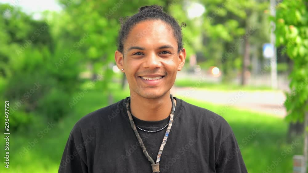 handsome smiling guy looking at the camera happy person close up face outdoors background summer city handsome smiling guy looking at the camera happy person close up face outdoors background summer city