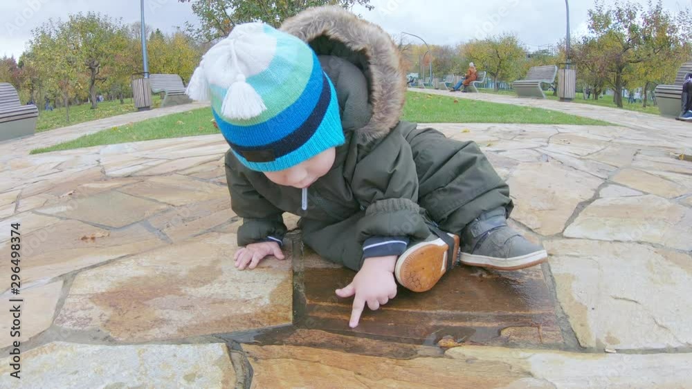Infant boy sits on marble tiles Infant boy sits on marble tiles