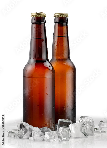 Two cold brown beer bottles with ice