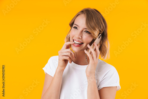Image of attractive blond woman smiling and talking on cellphone photo