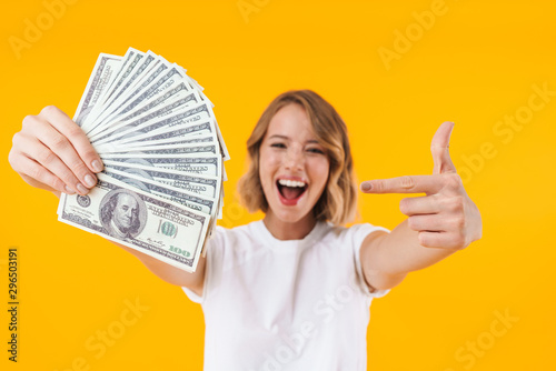 Image of excited blond woman holding bunch of money cash