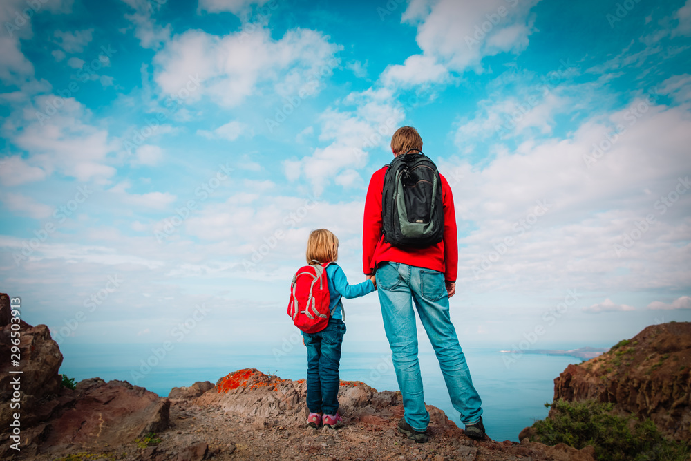 father and little daughter travel in mountains, family hiking in nature