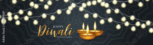 Happy Diwali - festival of lights banner or website header design. Indian traditional holiday background with glowing garland and text typography on a black backdrop with ornament. Diya oil lamp.
