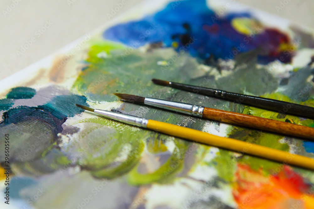 Fototapeta premium Colored Palette and oil Paint Brushes