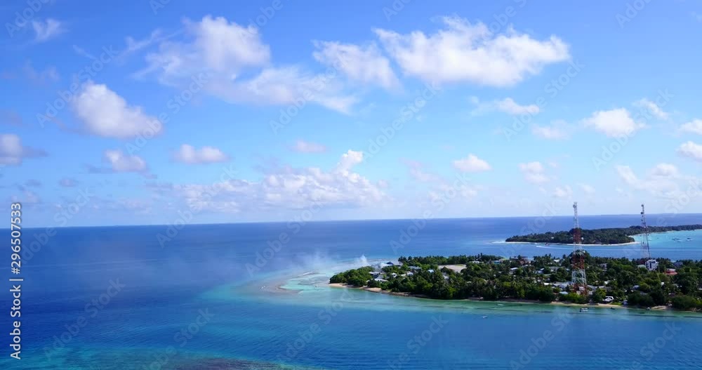Aerial view above a tropical island with large cell towers and smoke rising from the forest in the Philippines Aerial view above a tropical island with large cell towers and smoke rising from the forest in the Philippines
