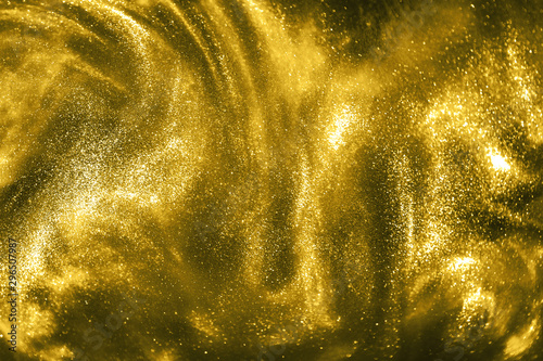 Abstract gold festive glitter magic shimmering luxury background. Festive sparkles and lights. de-focused