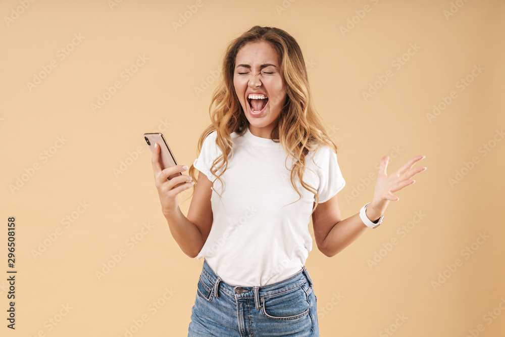Portrait of emotional woman screaming while holding cellphone Portrait of emotional woman screaming while holding cellphone