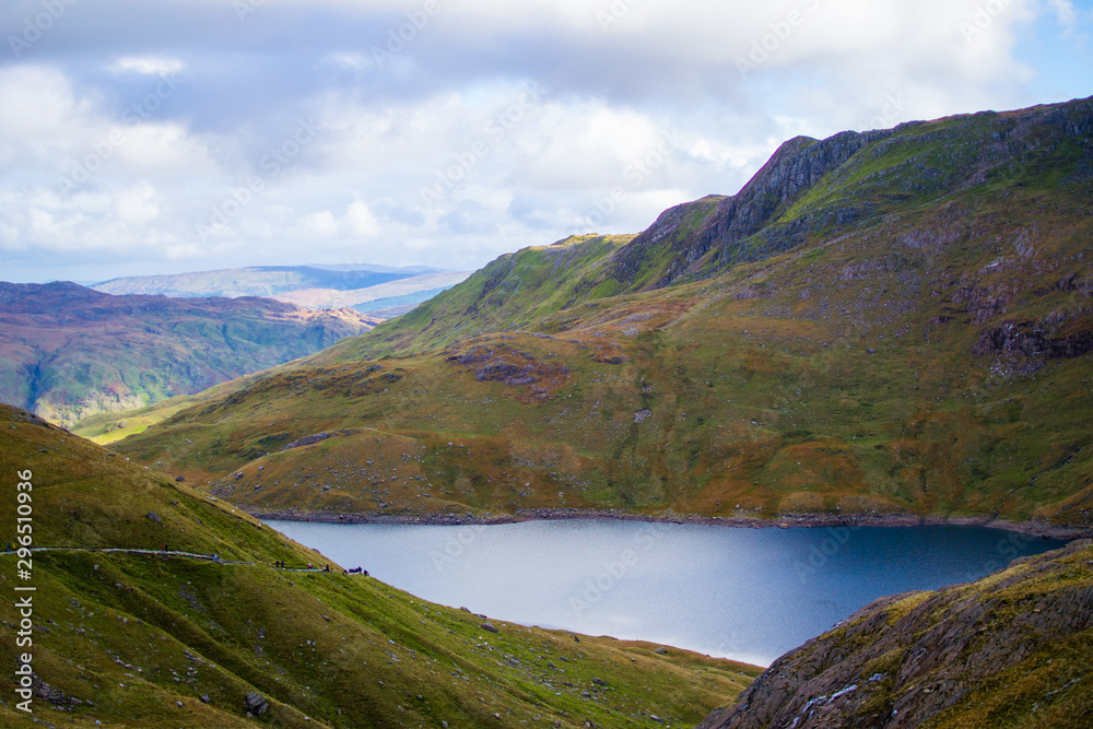 Lake in a small valley with mountains at the background in Snowdonia National Park in Wales Lake in a small valley with mountains at the background in Snowdonia National Park in Wales