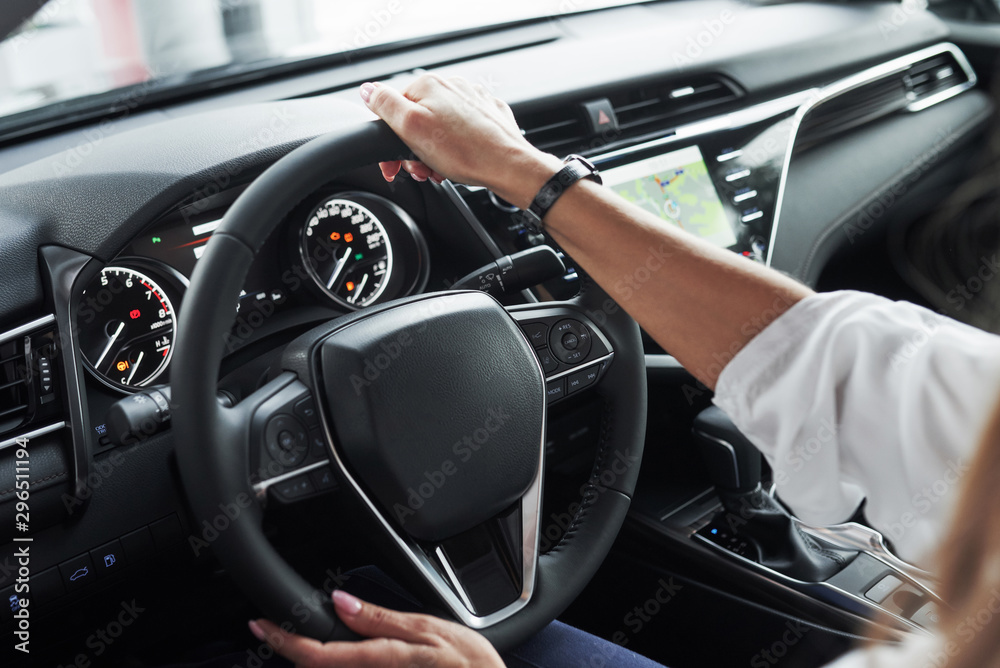 Everything is ready. Close up view of woman's hands in the beautiful modern black colored car