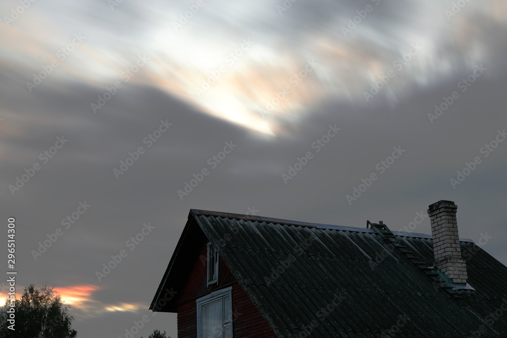 Late evening view of the village house roof against the sky