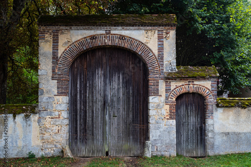 Fototapeta Naklejka Na Ścianę i Meble -  Large and small castle doors entrance  in rural France