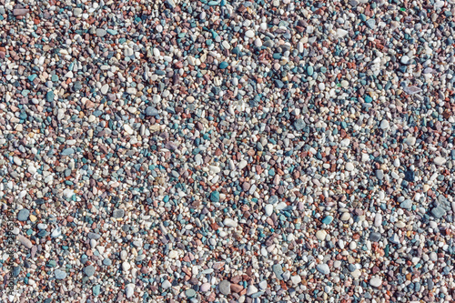 Multicolored texture of beach pebbles. Natural rocks background