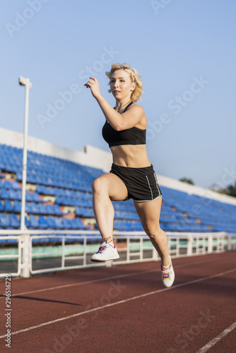 Sportive running woman training at stadium