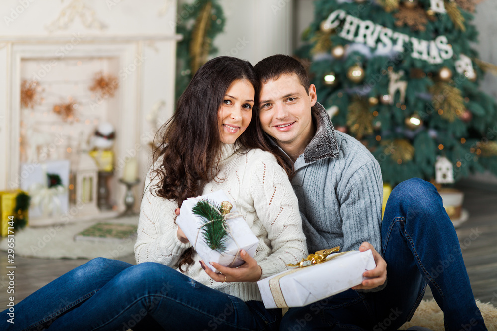 Young adult Couple celebrating Christmas together at Home Young adult Couple celebrating Christmas together at Home