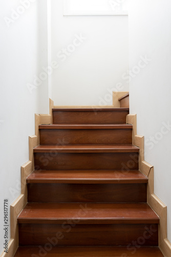 Vintage wooden staircase in home. The stairs up inside the house that painted the white walls.