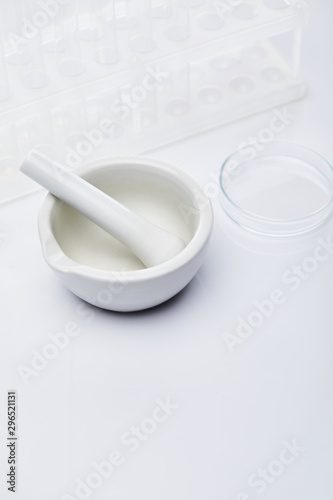 empty glass test tubes and mortar with pestle on white background background