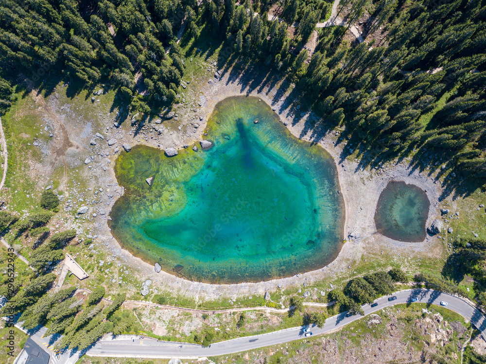 Carezza lake in Dolomitesn or Lago di Carezza, aerial view in the Dolomites, South Tyrol, Italy.