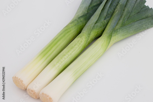Fresh green leeks in a white background. Catalogue style photo. Close up