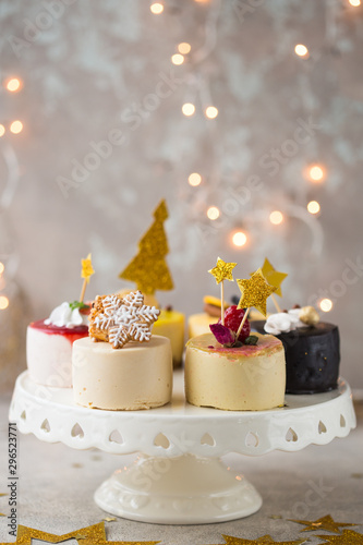 Christmas New year cheesecake or  mini cakes on plate. Close up. Holiday food.