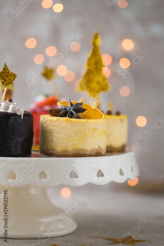 Christmas New year cheesecake or mini cakes on plate. Close up. Holiday food.