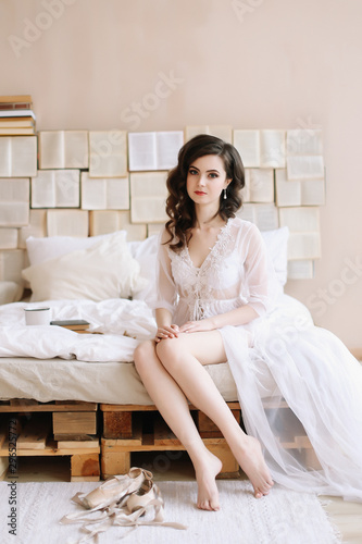 Bride in lingerie. Morning wedding gatherings. tenderness concept. Elegant classic wedding dress. 