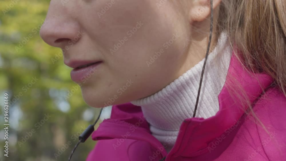 Close-up of an attractive Caucasian woman in pink sportswear having chest pain. Female runner feeling bad during the morning training in the autumn park. Sports and healthcare concept. Close-up of an attractive Caucasian woman in pink sportswear having chest pain. Female runner feeling bad during the morning training in the autumn park. Sports and healthcare concept.