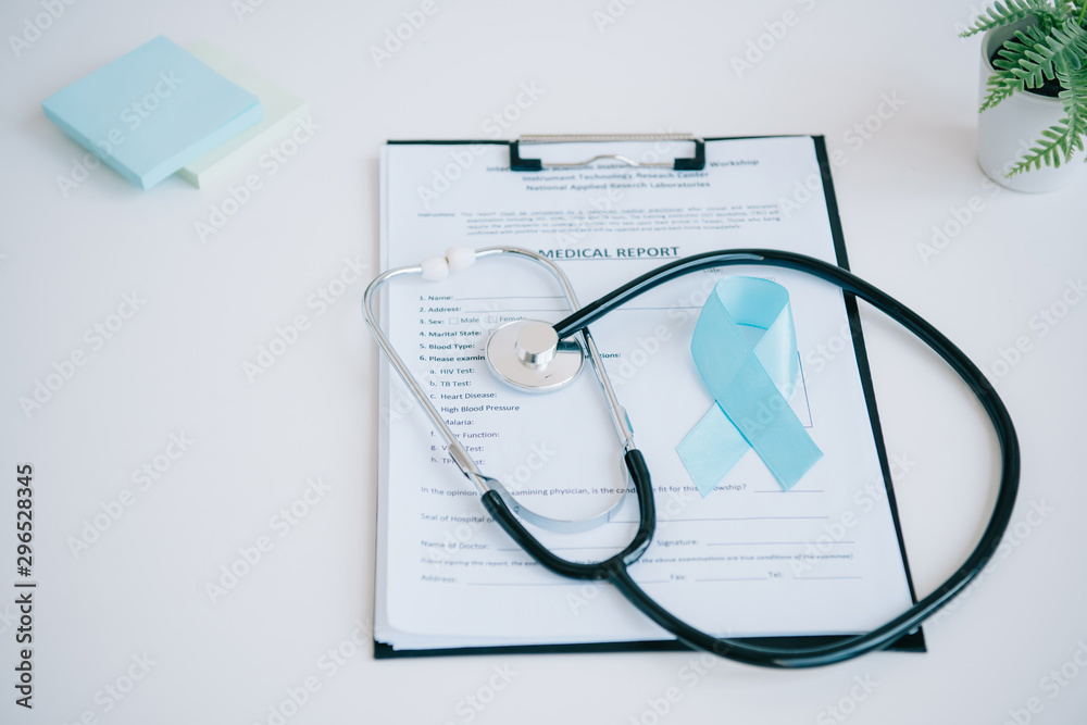 blue awareness ribbon, medical report, stethoscope and sticky notes on white table blue awareness ribbon, medical report, stethoscope and sticky notes on white table