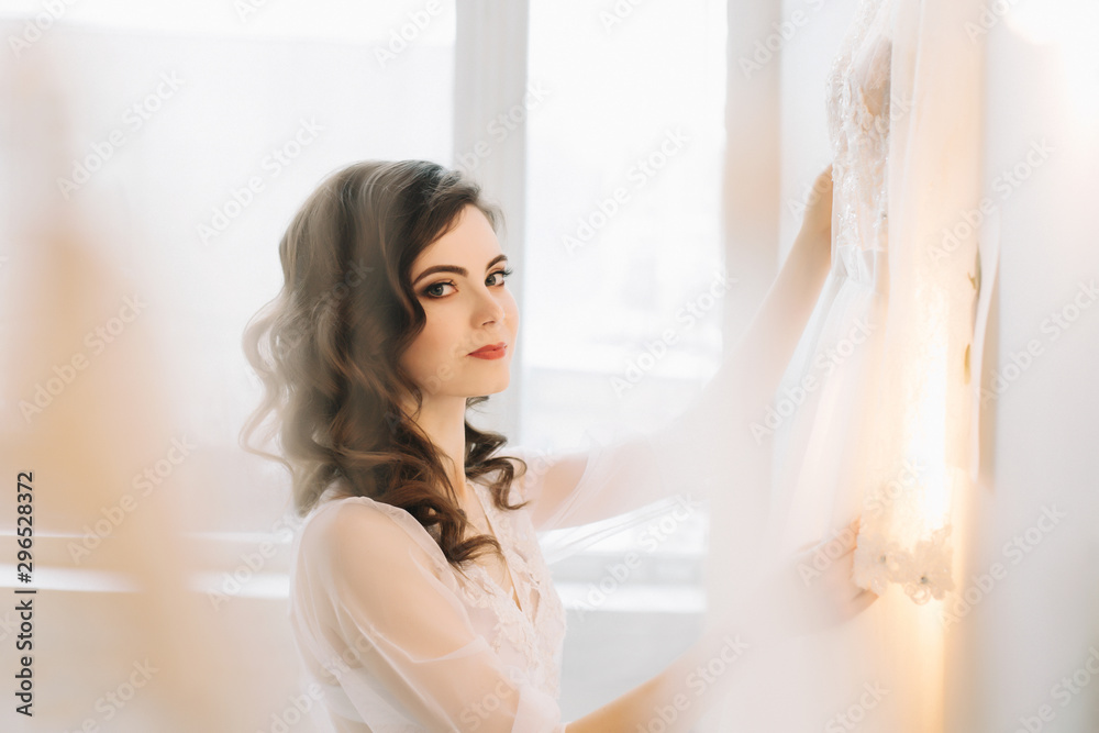 Bride in lingerie. Morning wedding gatherings. tenderness concept. Elegant classic wedding dress. Bride in lingerie. Morning wedding gatherings. tenderness concept. Elegant classic wedding dress.