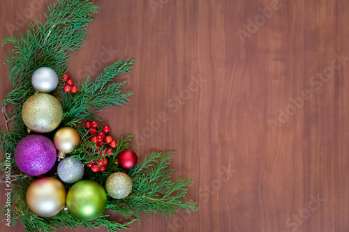 Christmas wooden background with fir branches and balls. New Year's decoration.
