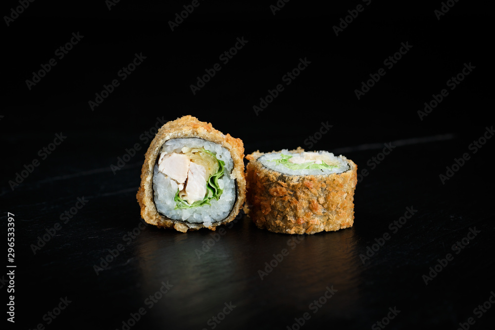 pair of tempura rolls close-up on a dark background pair of tempura rolls close-up on a dark background