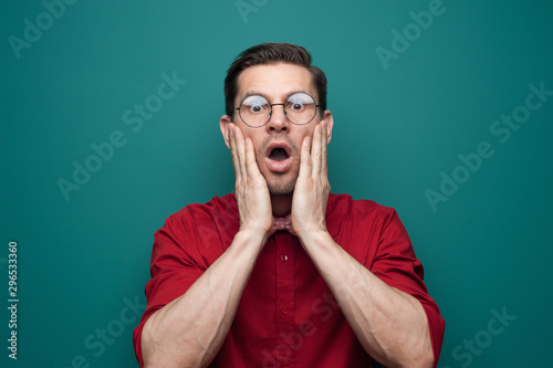 Close-up portrait of shocked young man in glasses © pavel_shishkin