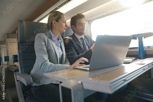 two colleagues working on a train