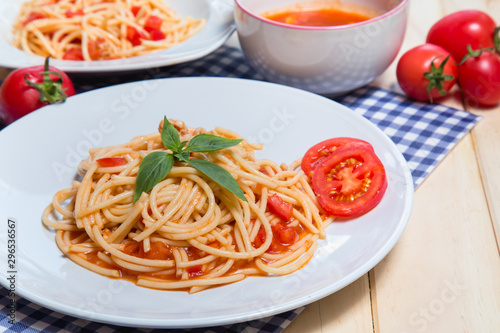 Spaghetti pasta with and tomato sauce on wood background