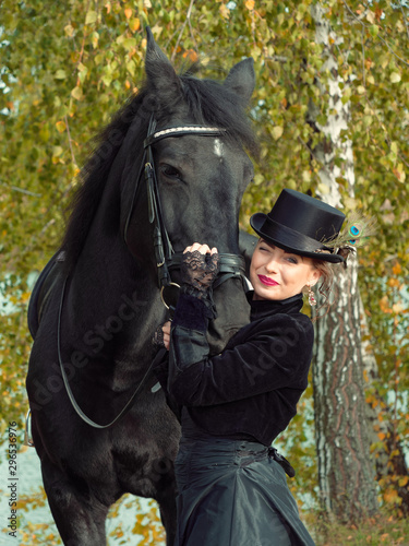 girl in a black dress with a black horse close-up
