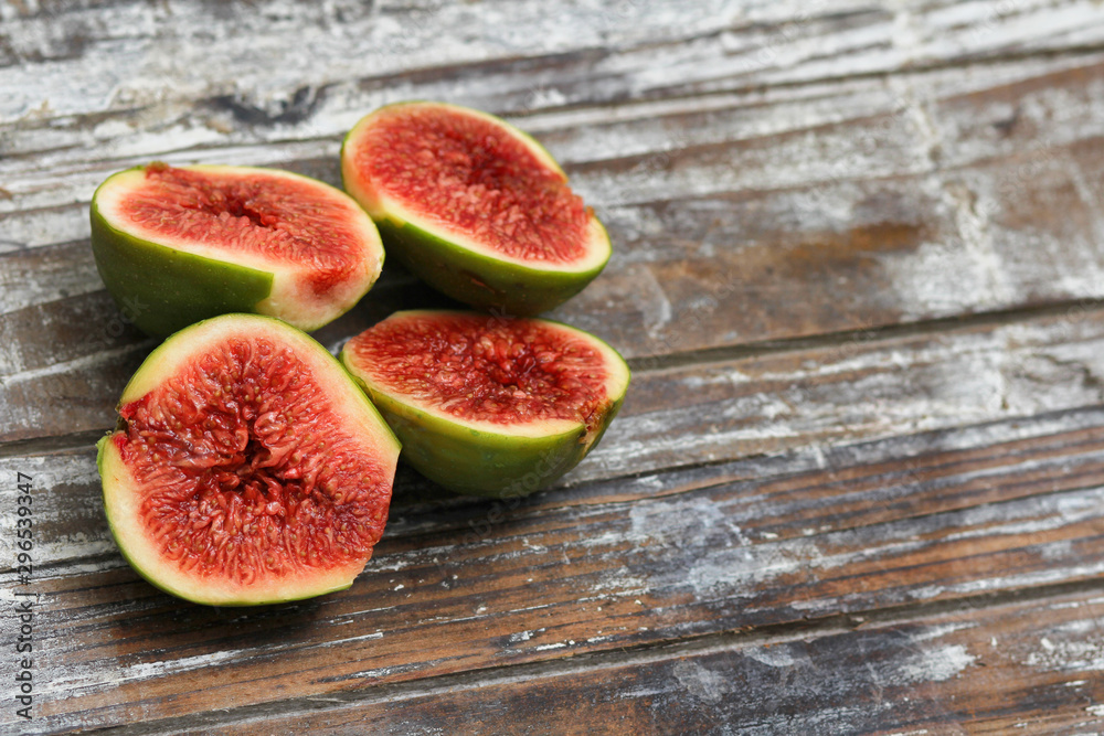 Sliced fig fruits. Decorative wooden background texture. Super foods concept. Organic food. Sliced fig fruits. Decorative wooden background texture. Super foods concept. Organic food.