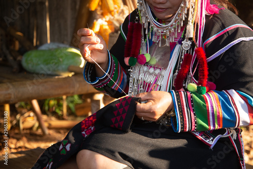 The Akha woman is sewing photo