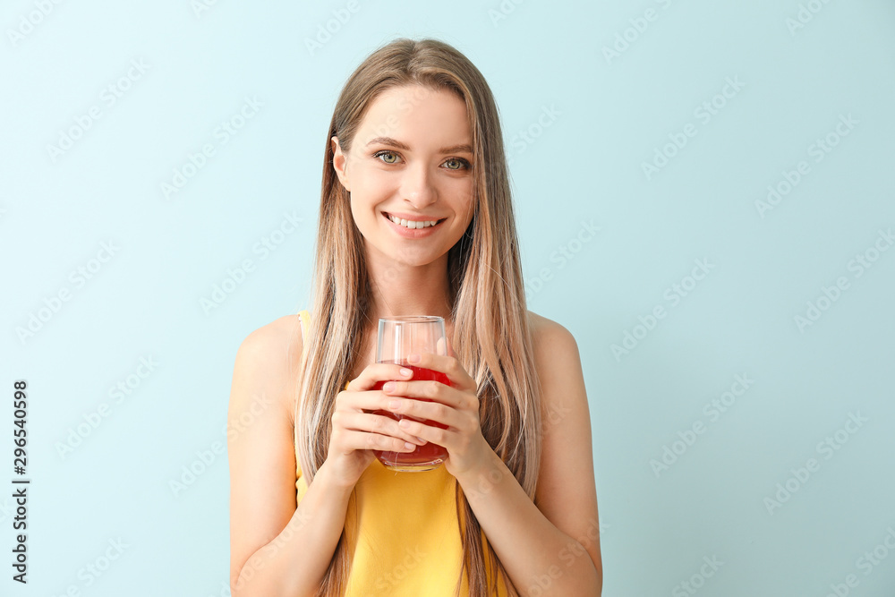 Woman with healthy juice on light background. Diet concept Woman with healthy juice on light background. Diet concept