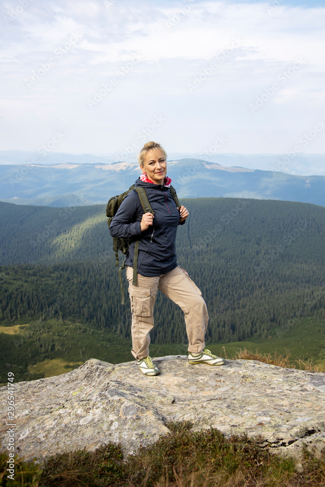 Hiker with backpack relaxing on top of the mountain. Hiker with backpack relaxing on top of the mountain.