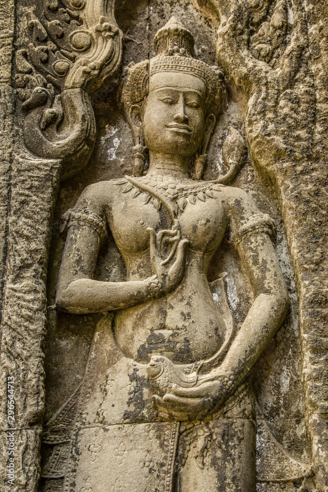 Detail of a Sculpture of a beautiful woman on the wall of an Angkor Wat temple, Cambodia