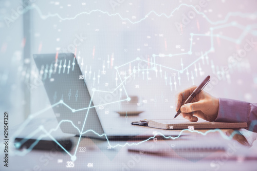 Multi exposure of forex chart with man working on computer on background. Concept of market analysis.