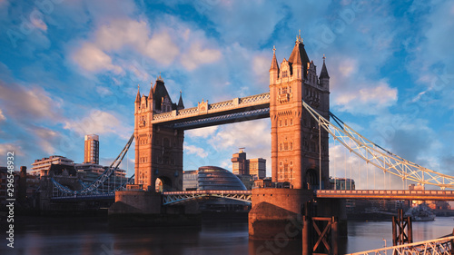 London, England, at sunrise. The famous Tower Bridge landmark with a colorful sky and clouds photographed at golden hour.
